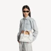 Borsa da donna Le City piccola con borchie giganti e strass in bianco ottico